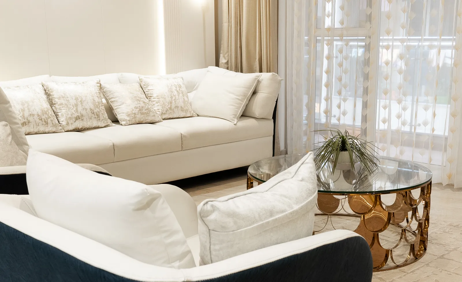 White sofa and copper-and-glass coffee table — Arna's Home